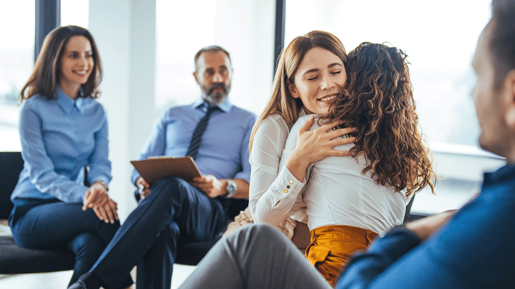 male therapist explaining how can family therapy help to a family in crisis