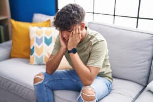 adolescent male seated in therapist's office discussing ways of finding depression treatment for teens in Omaha, NE.