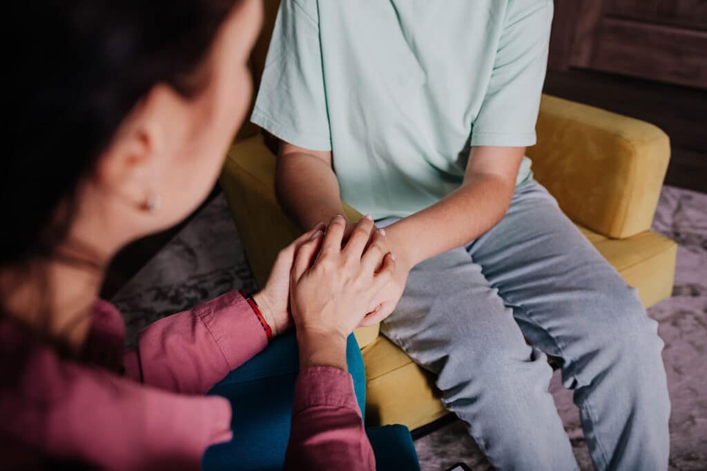 Concerned behavioral health specialist explaining to teenager the red flags to look for in relationships as a teen