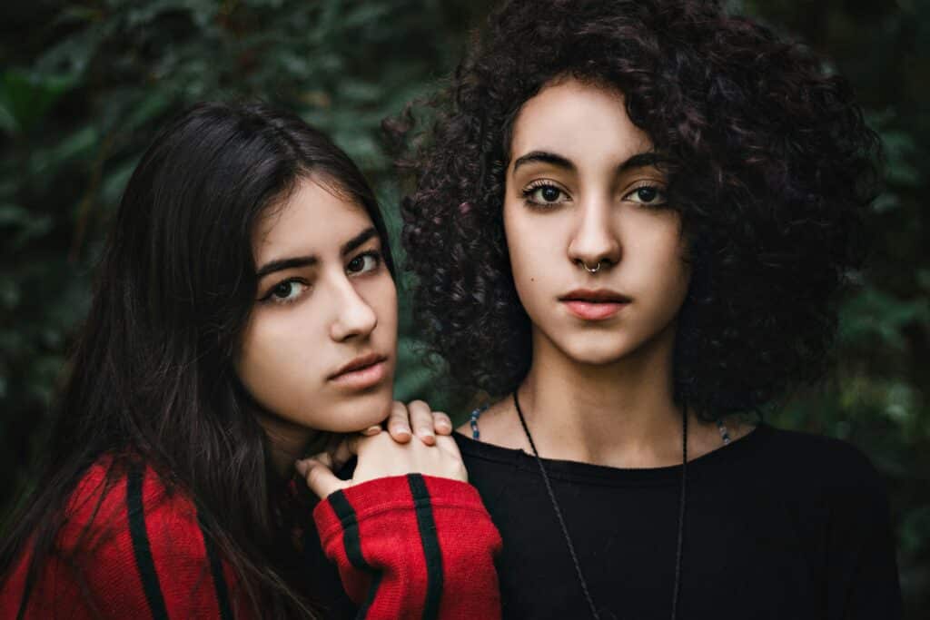girl leaning on the shoulder of her sister